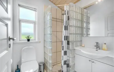a bathroom with a toilet and a sink at Beautiful Home In Vinderup With Sauna in Vinderup