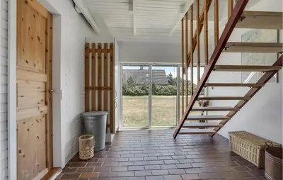 a staircase in a room with a door and a window at Awesome Home In Thisted With Kitchen in Thisted