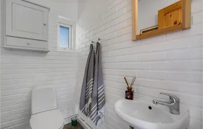 a white bathroom with a sink and a toilet at Awesome Home In Thisted With Kitchen in Thisted