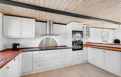 a kitchen with white cabinets and a wooden ceiling at Gorgeous Home In Højslev With Wifi in Højslev