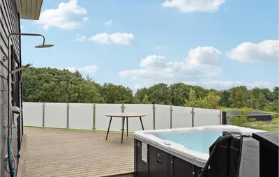 a patio with a table and a hot tub at Beautiful Home In Spøttrup With Wifi in Spottrup