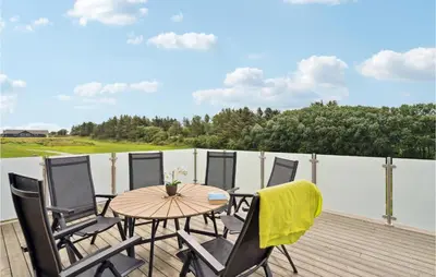 a patio with a table and chairs on a deck at Beautiful Home In Spøttrup With Wifi in Spottrup