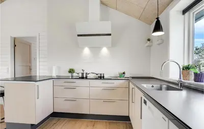 a kitchen with white cabinets and a sink at Cozy Home In Vestervig With Wifi in Vestervig