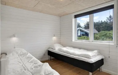a room with two beds and a window at Cozy Home In Vestervig With Wifi in Vestervig