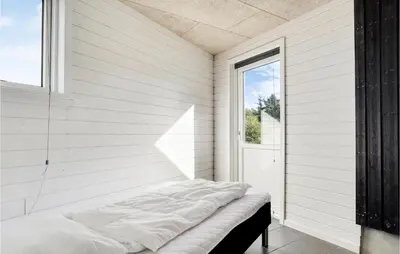 a bed sitting in a room with a window at Cozy Home In Vestervig With Wifi in Vestervig
