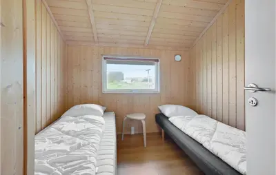 a small room with two beds and a window at 3 Bedroom Stunning Home In Thisted in Thisted