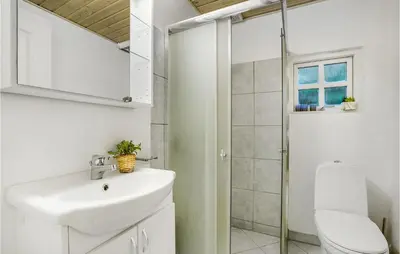 a white bathroom with a sink and a toilet at Amazing Home In Thyholm With Wifi in Thyholm