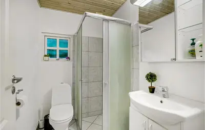 a bathroom with a shower and a toilet and a sink at Amazing Home In Thyholm With Wifi in Thyholm