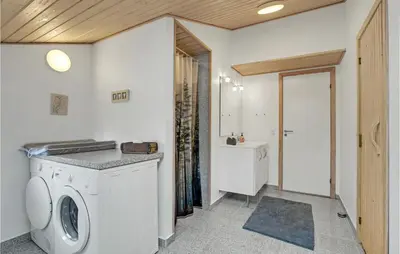 a laundry room with a washing machine and a sink at Cozy Home In Hurup Thy With Sauna in Sønder Ydby