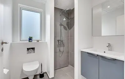 a bathroom with a shower and a toilet and a sink at Pet Friendly Home In Løgstrup With Wifi in Løgstrup