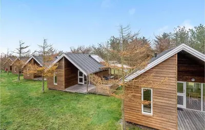 a row of log homes in a row at Nice Home In Hanstholm With Kitchen in Hanstholm