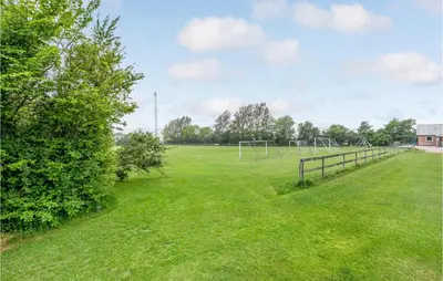 a large grass field with a soccer goal at Gorgeous Home In Nykøbing M With Wifi in Tødsø