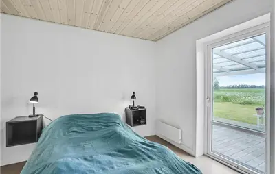a bedroom with a bed and a large window at Gorgeous Home In Vestervig With Wifi in Vestervig