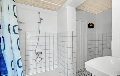 a white bathroom with a shower and a sink at Gorgeous Home In Vestervig With Wifi in Vestervig