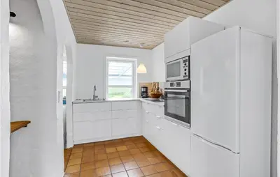 a kitchen with white cabinets and a window at Gorgeous Home In Vestervig With Wifi in Vestervig
