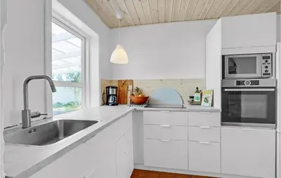 a white kitchen with a sink and a microwave at Gorgeous Home In Vestervig With Wifi in Vestervig