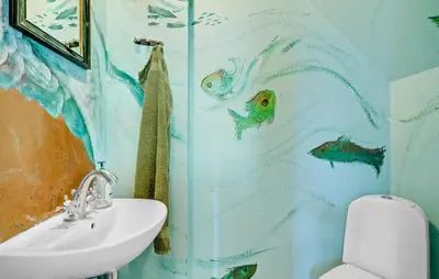 a bathroom with a shower curtain with fish on it at 6 Bedroom Amazing Home In Roslev in Roslev