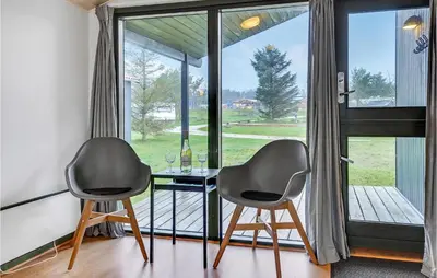 two chairs and a table in front of a window at 2 Bedroom Nice Home In Hanstholm in Hanstholm