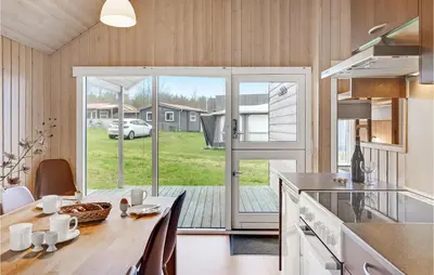 a kitchen with a dining table and a sliding glass door at Gorgeous Home In Hanstholm With Wifi in Hanstholm