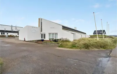 a white building sitting on the side of a road at Gorgeous Apartment In Brovst With Wifi in Brovst