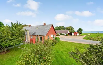 an aerial view of a red house and a road at 2 Bedroom Gorgeous Home In Roslev in Roslev