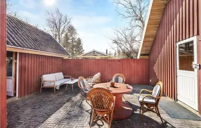 a patio with a table and chairs and a fence at 4 Bedroom Pet Friendly Home In Løgstør in Løgstør