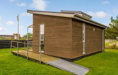 a small wooden building with a ramp in the grass at 1 Bedroom Nice Home In Vestervig in Vestervig