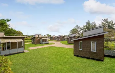 a row of houses in a yard with grass at 1 Bedroom Nice Home In Vestervig in Vestervig