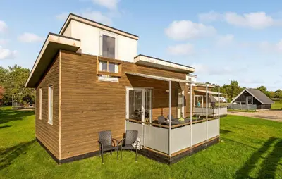a tiny house on the grass with two chairs at 1 Bedroom Nice Home In Vestervig in Vestervig
