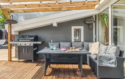 a patio with a table and a grill at Lovely Home In Thisted With Sauna in Thisted