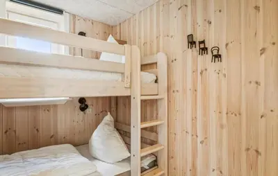 a bedroom with bunk beds in a wooden wall at Lovely Home In Thisted With Sauna in Thisted