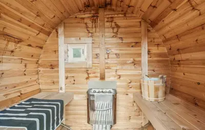 a wooden cabin with a stove in it at Lovely Home In Thisted With Sauna in Thisted