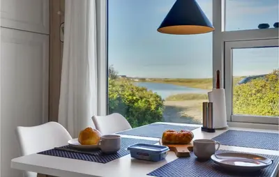 a dining room table with a view of the water at Lovely Home In Vestervig With Wifi in Vestervig
