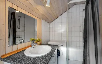 a bathroom with a sink and a washing machine at Lovely Home In Vestervig With Wifi in Vestervig