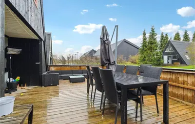 a black table and chairs on a wooden deck at Amazing Home In Farsø With Wifi in Farsø