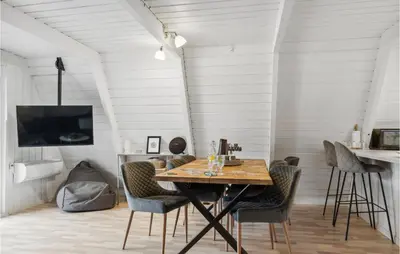 a dining room with a wooden table and chairs at Amazing Home In Farsø With Wifi in Farsø