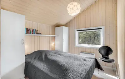 a bedroom with a bed and a window and a chair at 3 Bedroom Lovely Home In Vestervig in Vestervig