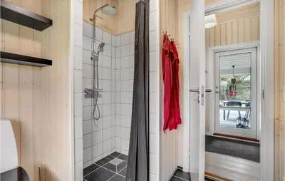 a bathroom with a walk in shower next to a door at 3 Bedroom Lovely Home In Vestervig in Vestervig