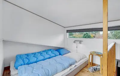a large blue couch in a room with a window at Cozy Home In Vestervig With Kitchen in Vestervig