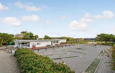 a park with a building and a playground at Cozy Home In Vestervig With Kitchen in Vestervig