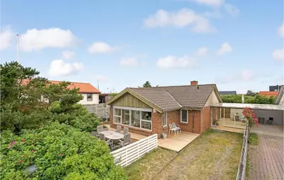 a brick house with a porch and patio at Gorgeous Home In Thisted in Torsted