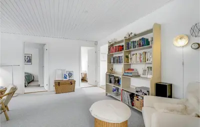 a white living room with a white couch and bookshelves at Gorgeous Home In Thisted in Torsted