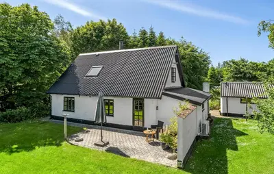 a white house with a black roof at 2 Bedroom Stunning Home In Bedsted Thy in Bedsted Thy