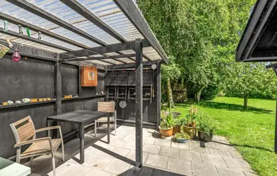a patio with a table and chairs under a pergola at 2 Bedroom Stunning Home In Bedsted Thy in Bedsted Thy