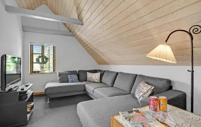 a living room with a couch and a table at 2 Bedroom Stunning Home In Bedsted Thy in Bedsted Thy
