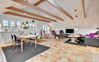 a living room with a table and chairs at Stunning Home In Roslev With Kitchen in Roslev