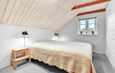 a bedroom with a bed and a window at Stunning Home In Roslev With Kitchen in Roslev