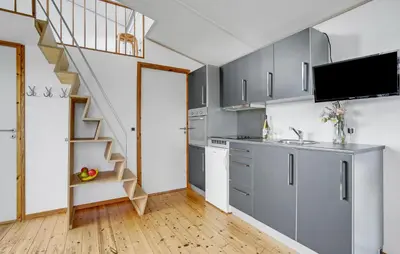 a kitchen with gray cabinets and a staircase at Beautiful Home In Vestervig With Wifi in Vestervig