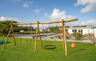 a playground with a swing set in a park at Gorgeous Home In Vestervig With Kitchen in Vestervig