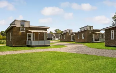a row of houses in a yard with grass at Lovely Home In Vestervig With Kitchen in Vestervig
